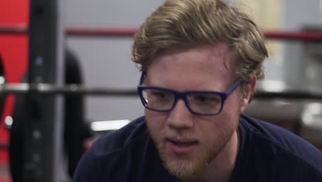 young aged caucasian boy feeling exhausted after exercise in gym