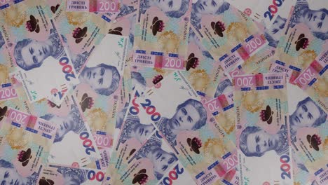 200 ukrainian hryvnia bills background. many banknotes.