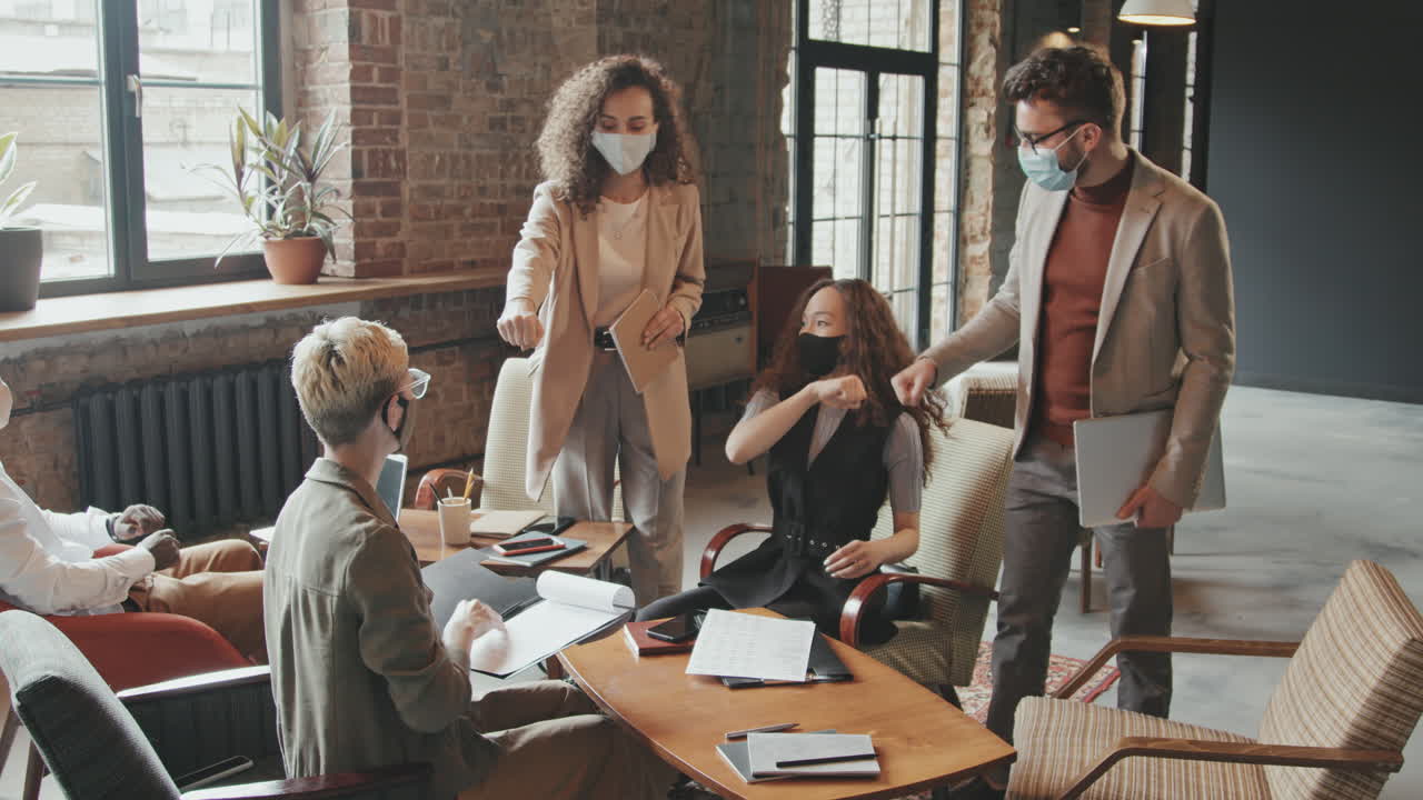 Team of Coworkers in Face Masks Meeting