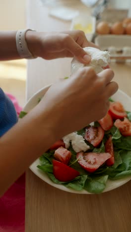 person eating a salad with mozzarella and tomato