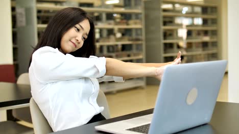 4k slow motion : portrait of a sleepy beautiful asian student girl using laptop in library