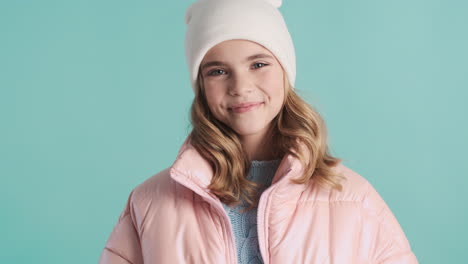 Teenage-Caucasian-girl-with-winter-clothes-smiling-at-the-camera.