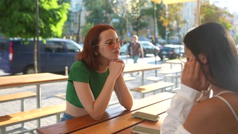 two young women friends chatting outdoors