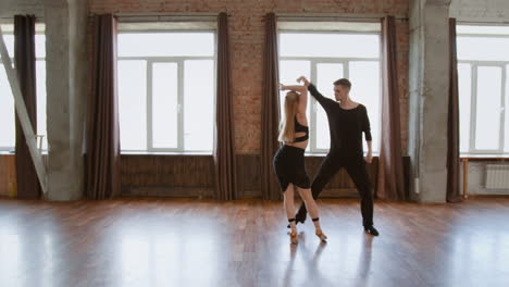 Couple dancing and practicing in a spacious studio