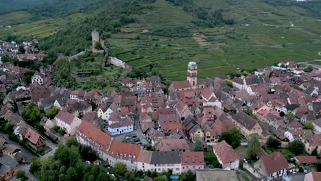 aerial view of the picturesque village of kaysersberg in alsace, france, showcasing charming half-timbered houses, a medieval church, and the ruins of château de kaysersberg