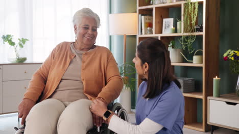 senior woman in wheelchair talking with her caregiver