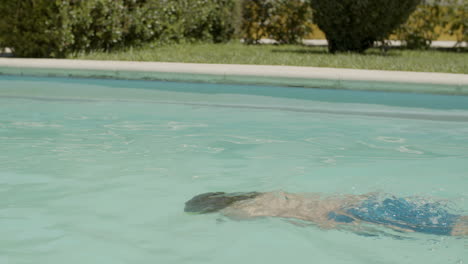 three caucasian brothers spending time together and having fun in the swimming pool on a summer day