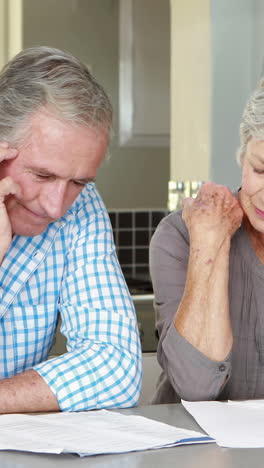 senior couple counting bills