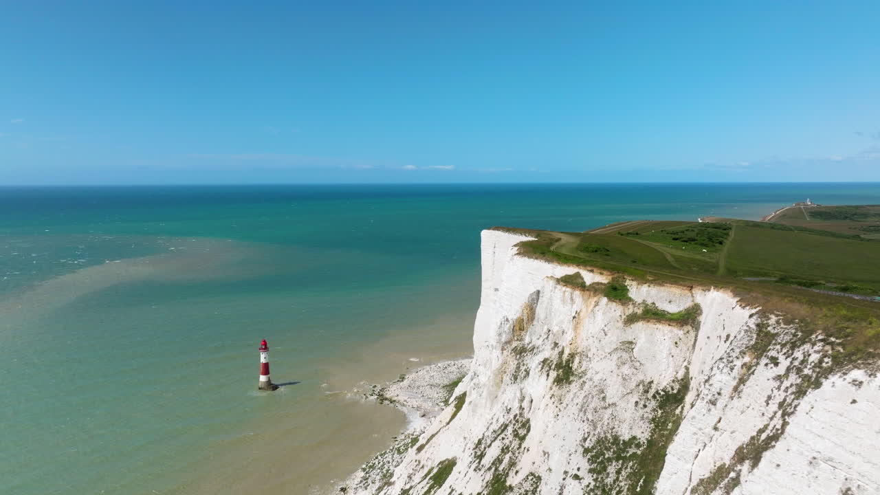 Coastal Walk On Seven Sisters Cliffs Overlooking The Beachy Head Lighthouse And English Channel In Sussex, England, UK. - aerial shot