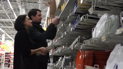 couple shopping for dishes in a supermarket