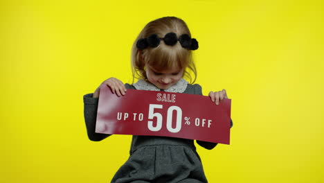 Child-girl-showing-Up-To-50-percent-Off-Sale-inscription,-advertising-discounts.-Black-Friday