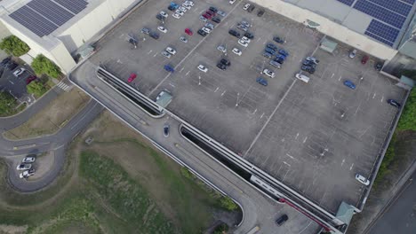 flying above robina town centre carpark with rooftop solar panels in robina town, gold coast, queensland