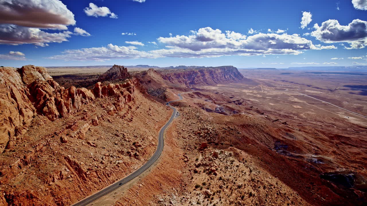 Aerial view reveals a dramatic pass slicing through the rugged red rocks of Page, Arizona.