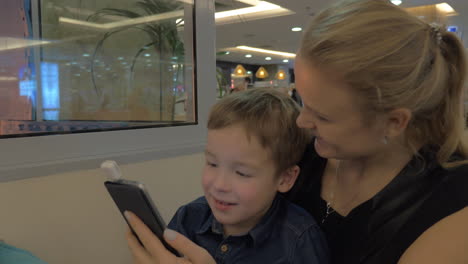 Mother-and-son-paying-with-mobile-card-reader