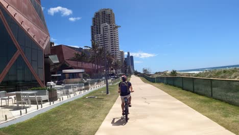 child riding scooter on sunny coastal pathway