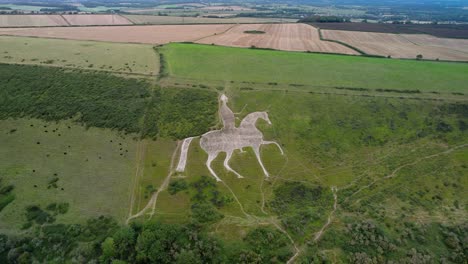 osmington white horse historical chalk figure art on hillside slope aerial view push in tilt down