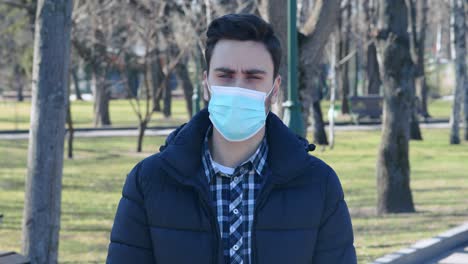 man wearing face mask in a park