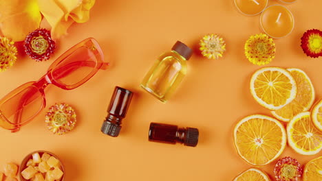 orange essential oil flat lay with decorations