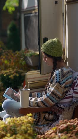 woman drawing on a tablet outdoors in an rv