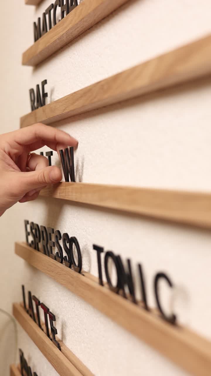 Person ordering coffee from a custom menu board