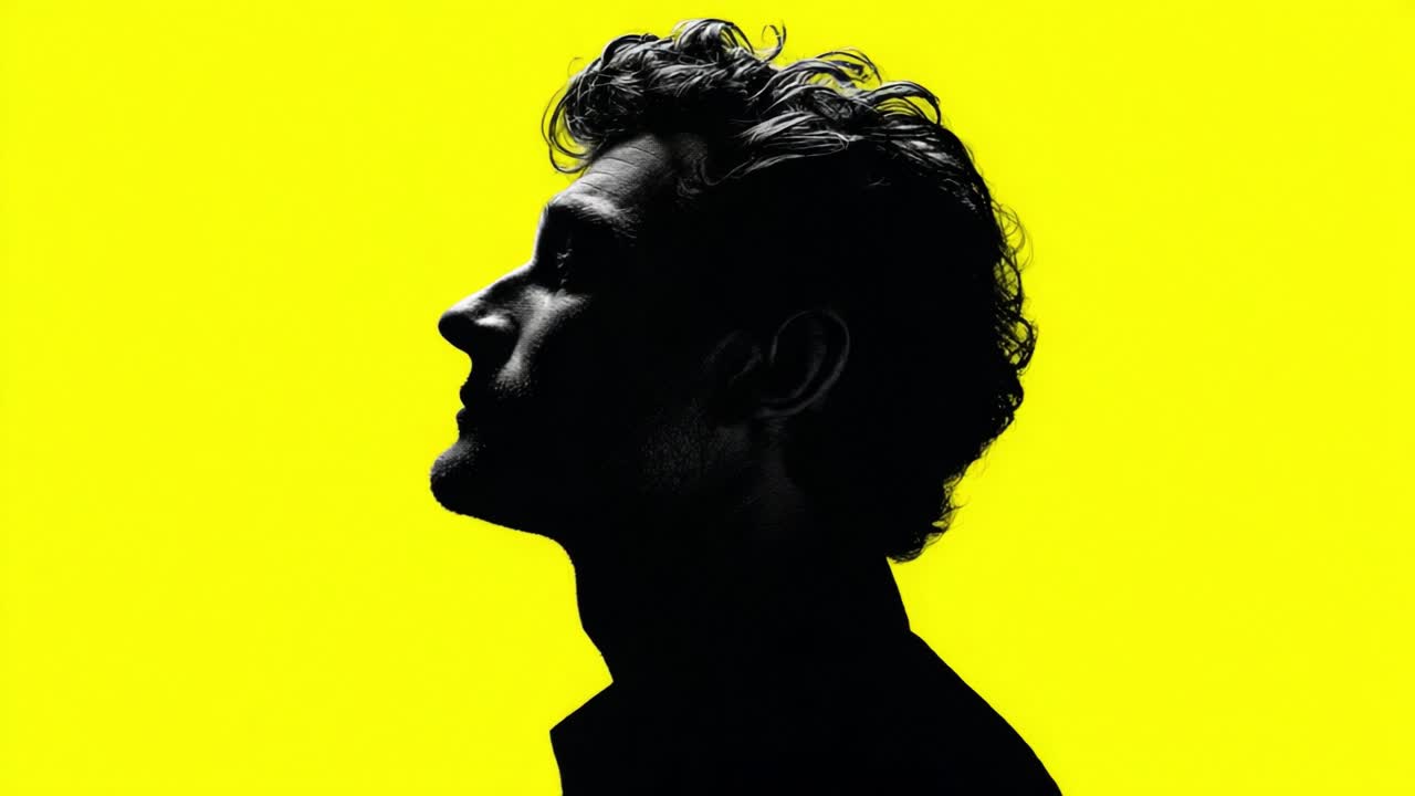 A striking silhouette of a thoughtful individual against a vibrant yellow backdrop, capturing an introspective moment that evokes curiosity and creativity