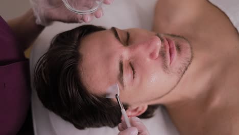 man receiving facial treatment