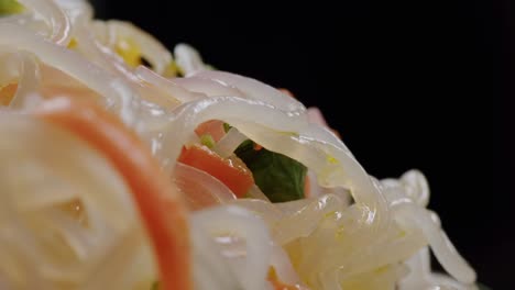 glass noodles salad with meat and carrots fermented close up asian chinese traditional food.
