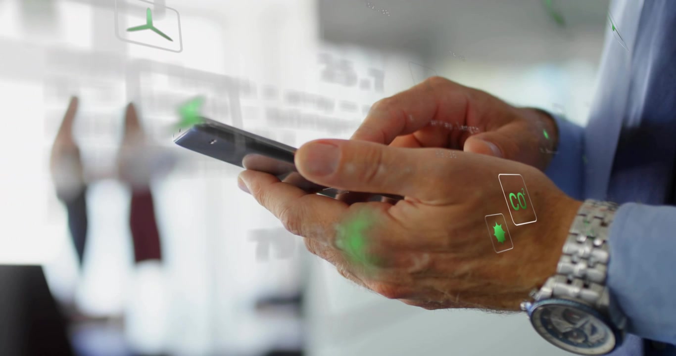 Man holding smartphone in business, finger tapping swiping, green icons shifting showing data