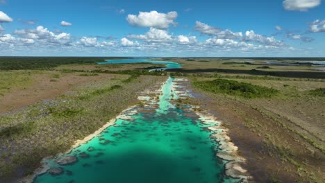 aerial view rising over a narrow spot of the rapidos de bacalar, in sunny mexico