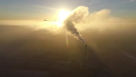 Dense-fog-over-city-Valmiera-in-early-winter-morning-sunlight-aerial-footage-wide-shot