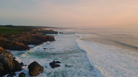 evening rocky coastal landscape aerial. foaming sea splashing on rough cliffs