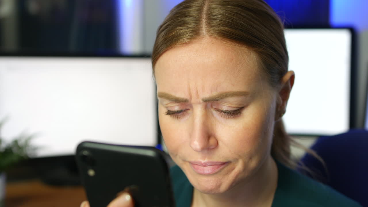 Stressed and frustrated girl using a phone in an office