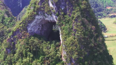 This-footage-captures-a-detailed-close-up-view-of-the-natural-hole-in-Angel-Eye-Mountain-in-Cao-Bang,-North-Vietnam