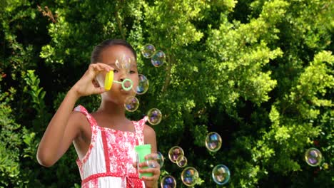 Little-girl-doing-soap-bubble-with-a-toy