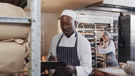 portrait of diverse bakers in bakery, talking on smartphone and counting products in slow motion
