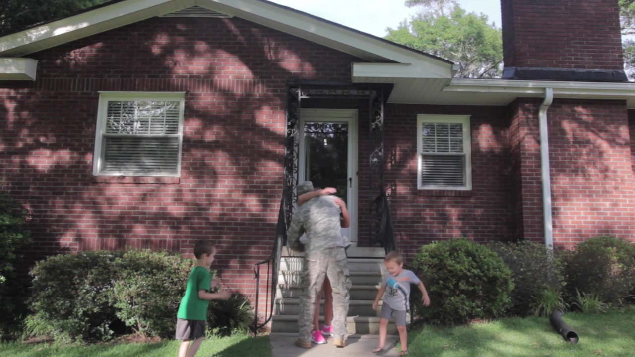 Family Welcoming Husband Home On Army Leave