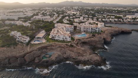 establishing shot at sunset of the touristic town of cala de oro in the spanish island of mallorca next to the mediterranean sea