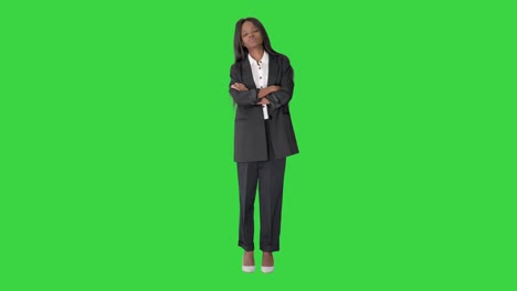 confident african american businesswoman with crossed arms on a green screen, chroma key