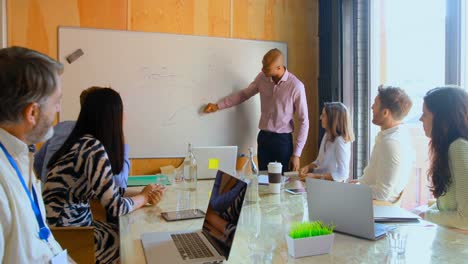 Businessman-giving-presentation-in-conference-room-4k