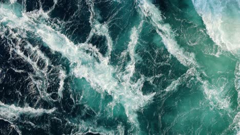 blue waves of water of the river and the sea meet each other during high tide and low tide.