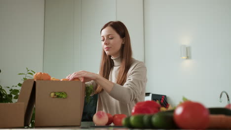 mujer desempaquetando verduras