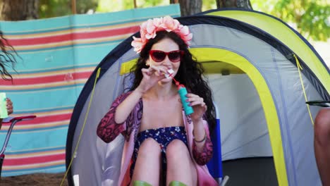 group of friends blowing bubbles at music festival 4k