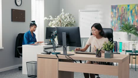 busy afternoon at the office, accounting department, marketing, two elegant women work in front of computers, create documents, plan strategy, enter bills into the system