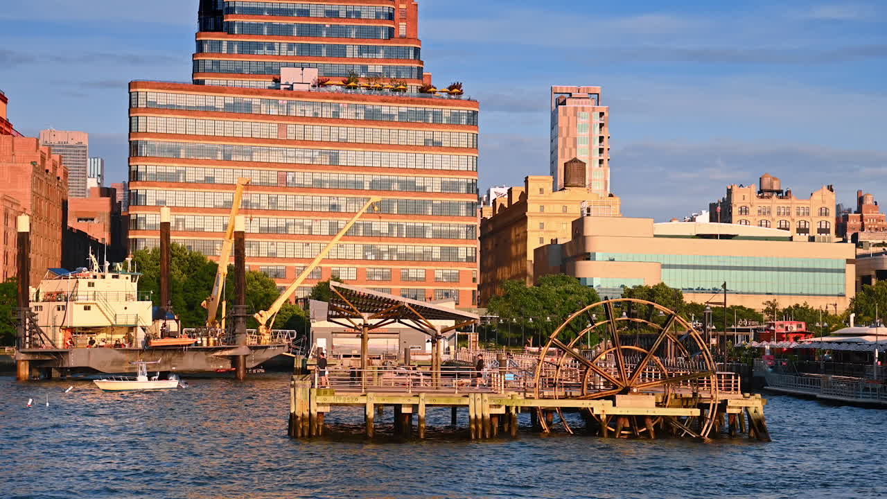 New York, USA, 4 August 2025: Chelsea waterfront with industrial pier and Manhattan buildings. Industrial pier at Chelsea waterfront with Manhattan residential