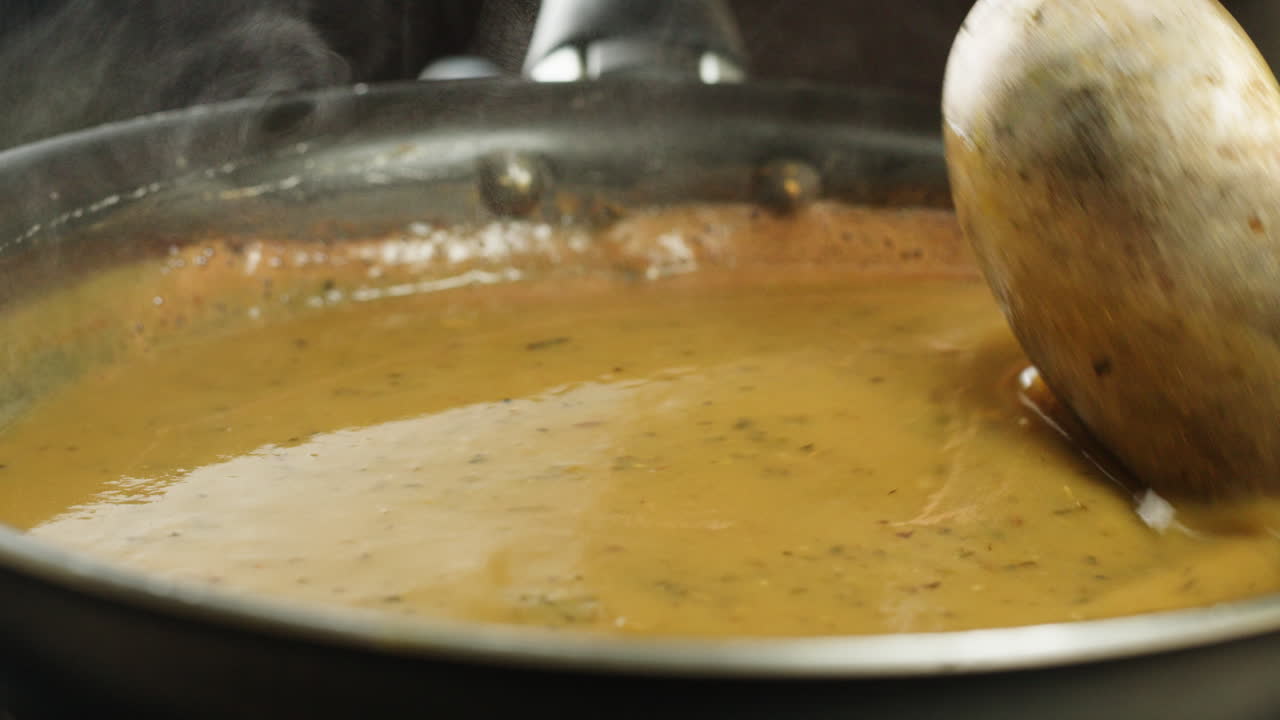 Cooking traditional Indian meal Palak Panir with spinach and cheese close up. Palak paneer is an Indian dish, consisting of paneer in a thick paste made from pureed spinach, Palak paneer is prepared by first boiling and pureeing spinach.