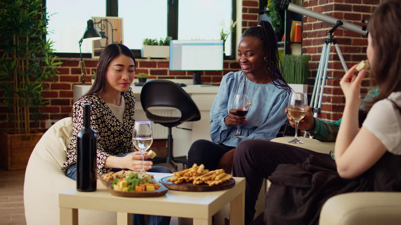 Multiracial women at brunch gathering trying out gourmet cheese from charcuterie board