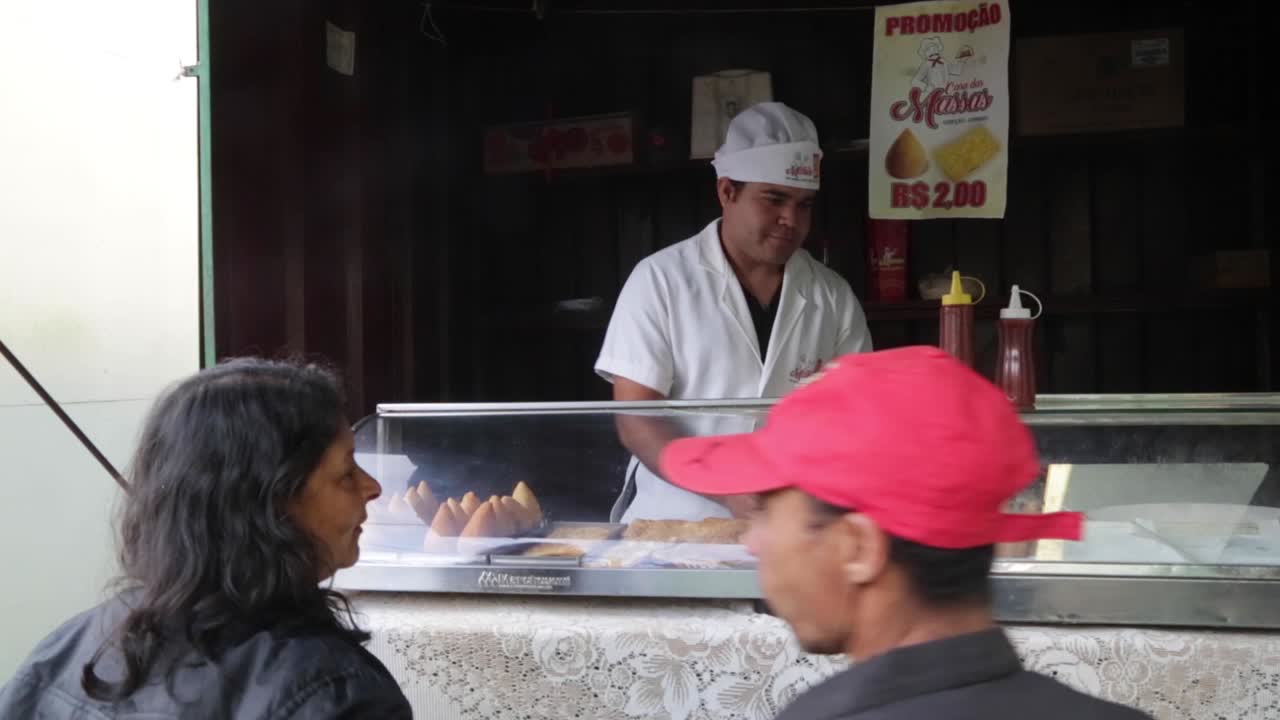 People waiting for their food at a street market in Capelinha, Minas Gerais, Brazil