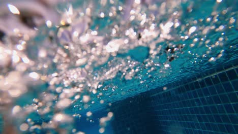 slow motion flow of bubbles underwater in the pool