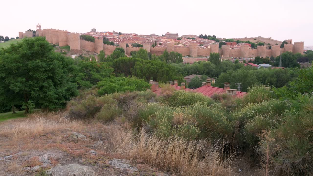 Landscape establishing shot of Avila, featuring the old town and its medieval walls, a UNESCO World Heritage Site.