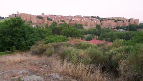 Landscape establishing shot of Avila, featuring the old town and its medieval walls, a UNESCO World Heritage Site.